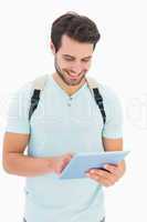 Handsome student using his tablet pc