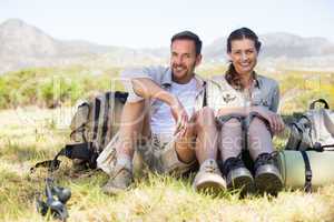 Happy hiking couple taking a break on mountain trail