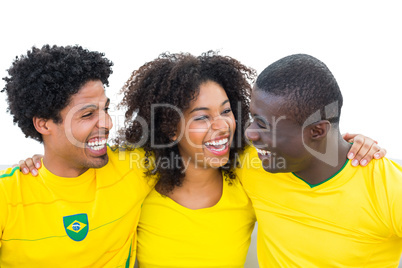 Happy brazilian football fans in yellow smiling at each other