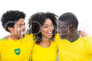 Happy brazilian football fans in yellow smiling at each other