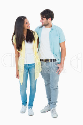 Happy casual couple smiling at each other Happy casual couple smiling at each other