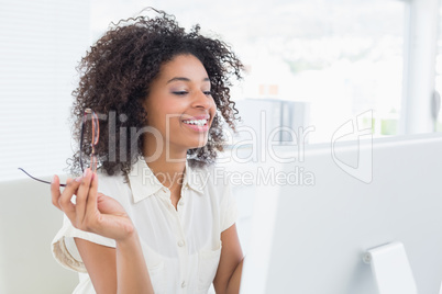 Pretty casual businesswoman working at desk