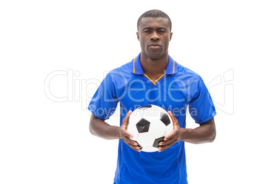 Football player in blue holding the ball
