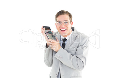 Geeky smiling businessman holding calculator