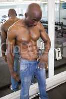 Muscular man wearing loose jeans