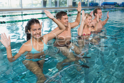 Fitness class doing aqua aerobics on exercise bikes