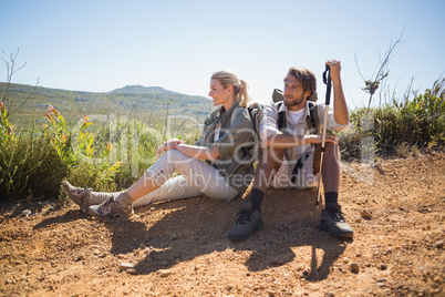 Hiking couple taking a break on mountain terrain