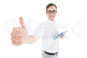 Geeky businessman holding his tablet showing thumbs up