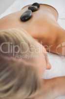 Beautiful blonde enjoying a hot stone massage