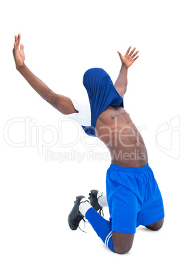 Football player in blue celebrating a win