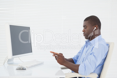 Businessman listening to music while he works