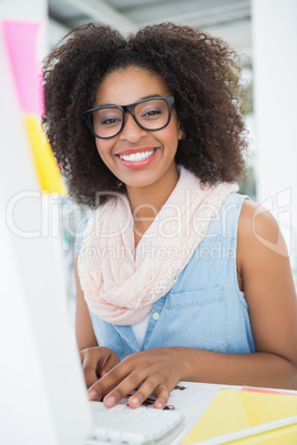 Pretty young hipster businesswoman smiling at camera