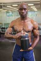 Muscular man with nutritional supplement