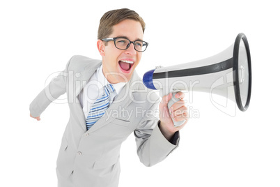 Geeky businessman shouting through megaphone