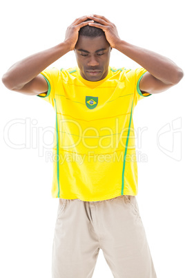 Disappointed brazilian football fan looking down