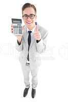 Geeky smiling businessman showing calculator