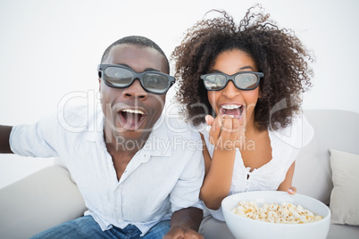 Couple sitting on couch together watching 3d movie