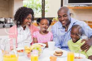 Happy family having breakfast together in the morning