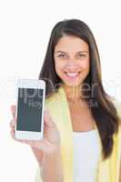 Happy casual woman showing her smartphone