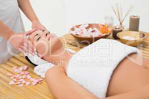 Peaceful brunette enjoying a head massage