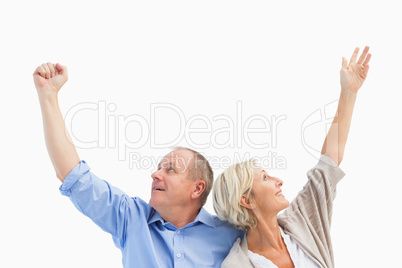 Happy mature couple with hands up