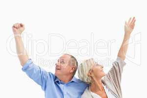 Happy mature couple with hands up