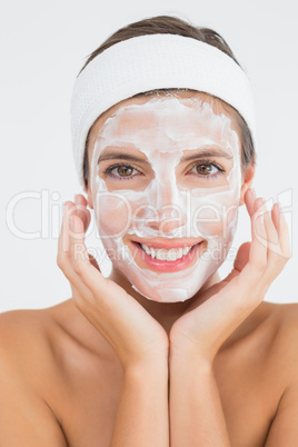 Attractive woman having white cream on her face