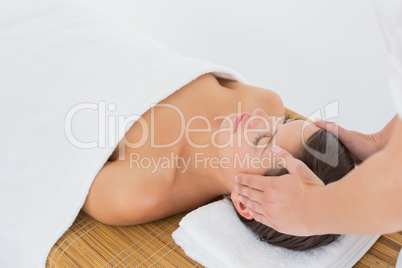 Attractive woman receiving head massage at spa center