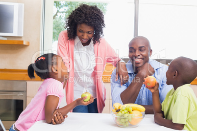 Happy family having fruit together