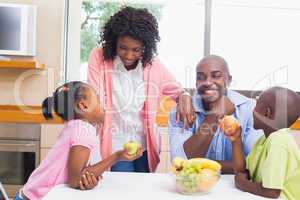 Happy family having fruit together