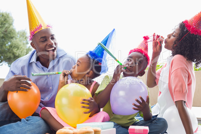 Happy family celebrating a birthday together in the garden