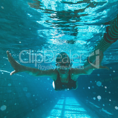 Athletic swimmer swimming towards camera