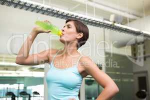Fit brunette drinking energy drink