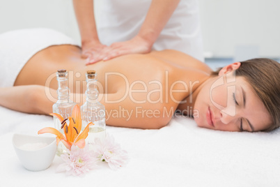 Attractive woman receiving back massage at spa center