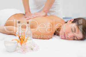 Attractive woman receiving back massage at spa center