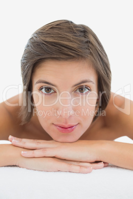 Close up portrait of a beautiful young woman on massage table