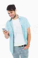 Happy casual man sending a text message