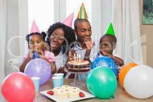 Happy family celebrating a birthday together at table