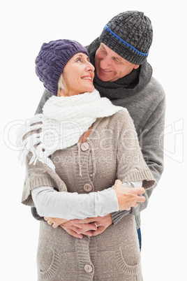 Happy mature couple in winter clothes embracing