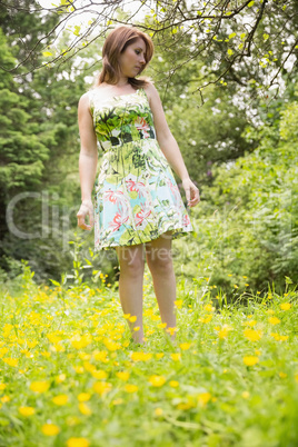 Cute young woman standing in field