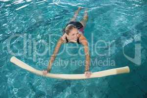 Fit blonde swimming with foam roller