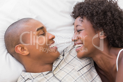 Happy couple lying in bed together