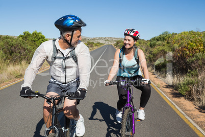 Active couple going for a bike ride in the countryside
