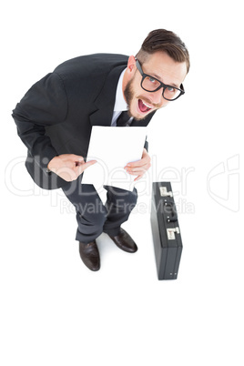 Geeky smiling businessman showing paper