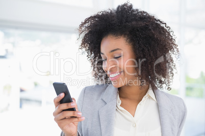 Casual businesswoman texting on phone