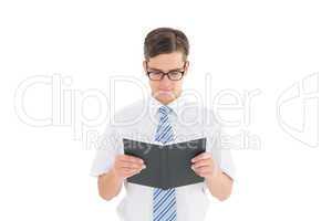 Geeky businessman reading from book