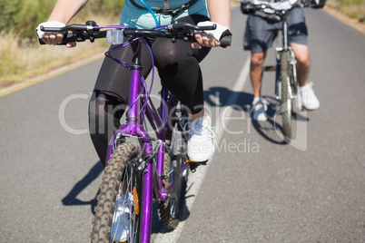 Fit couple going for a bike ride in the countryside