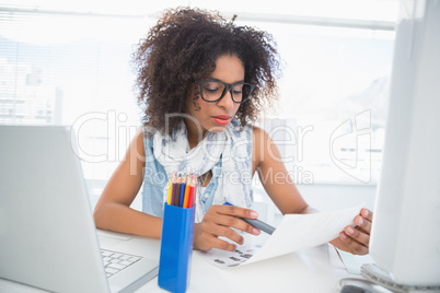 Pretty photo editor working at her desk