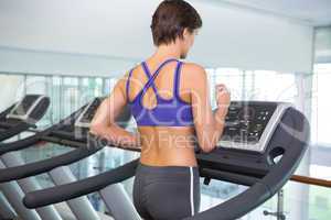 Fit brunette running on the treadmill