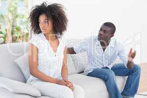 Attractive couple having an argument on couch